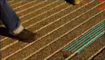 From the video: grooves in the road.  The ratio between the spacing and groove width looks like 4-to-1.